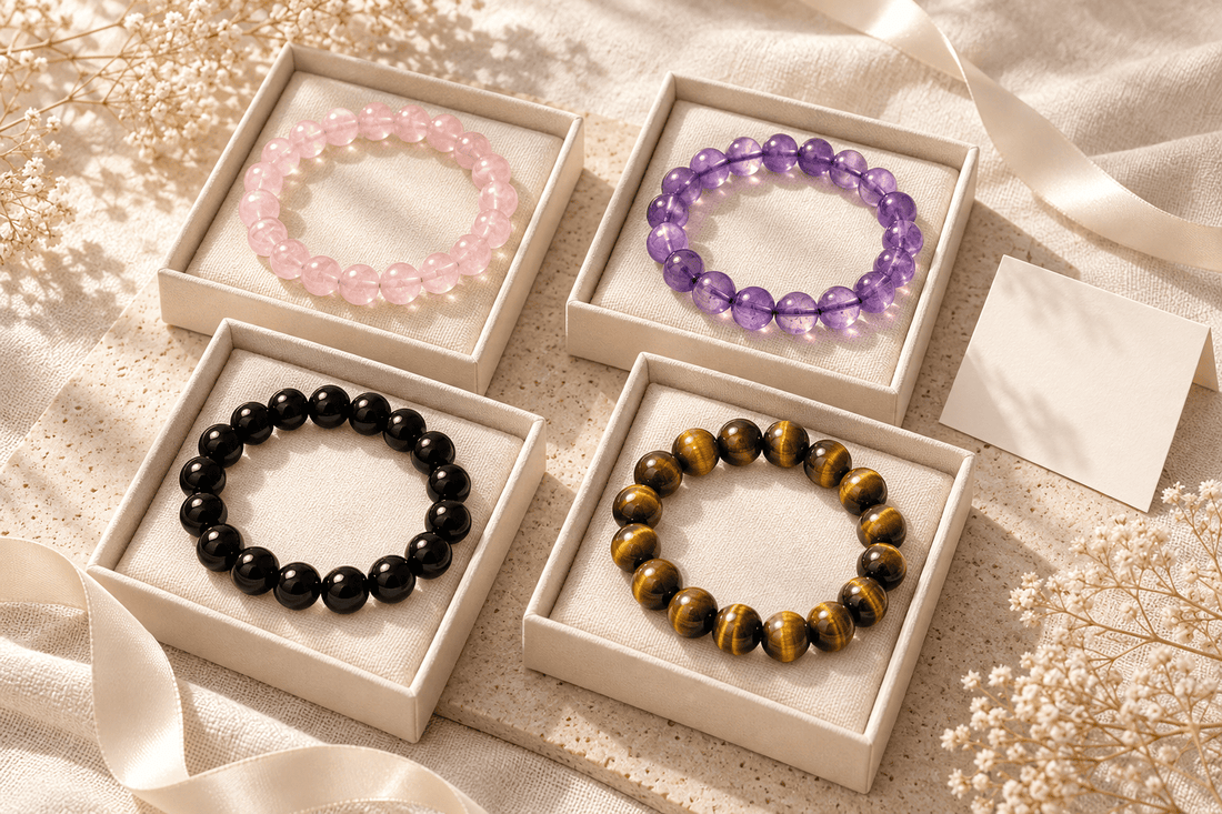 Crystal bracelet gift guide featuring rose quartz, amethyst, black obsidian and tiger eye bracelets in gift boxes