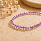 Amethyst crystal bracelet with small purple beads in warm natural light