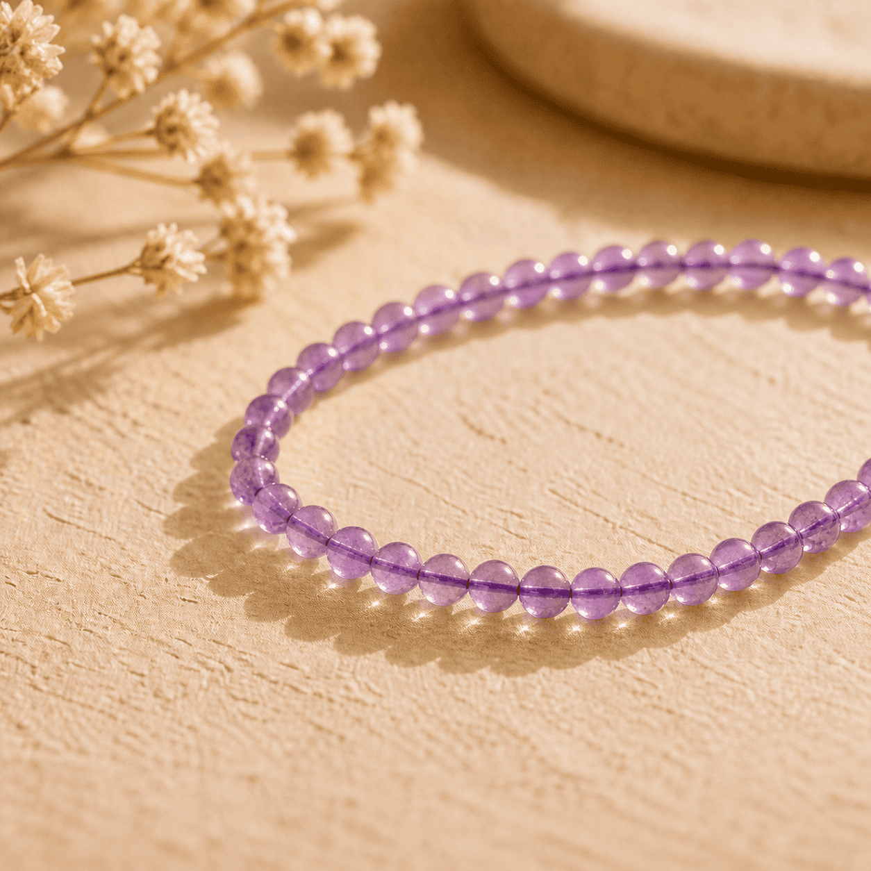 Amethyst crystal bracelet with small purple beads in warm natural light