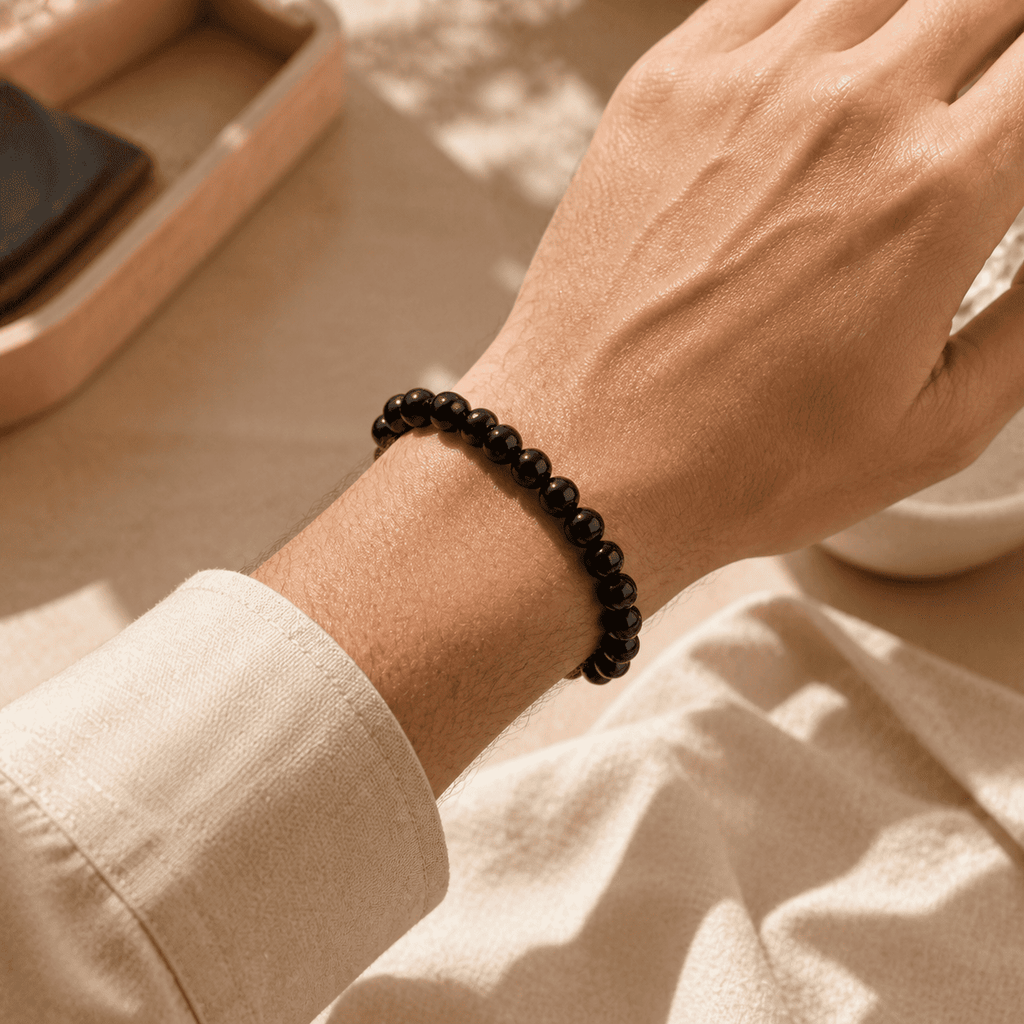 Black obsidian bracelet for men worn on the wrist with small polished round beads