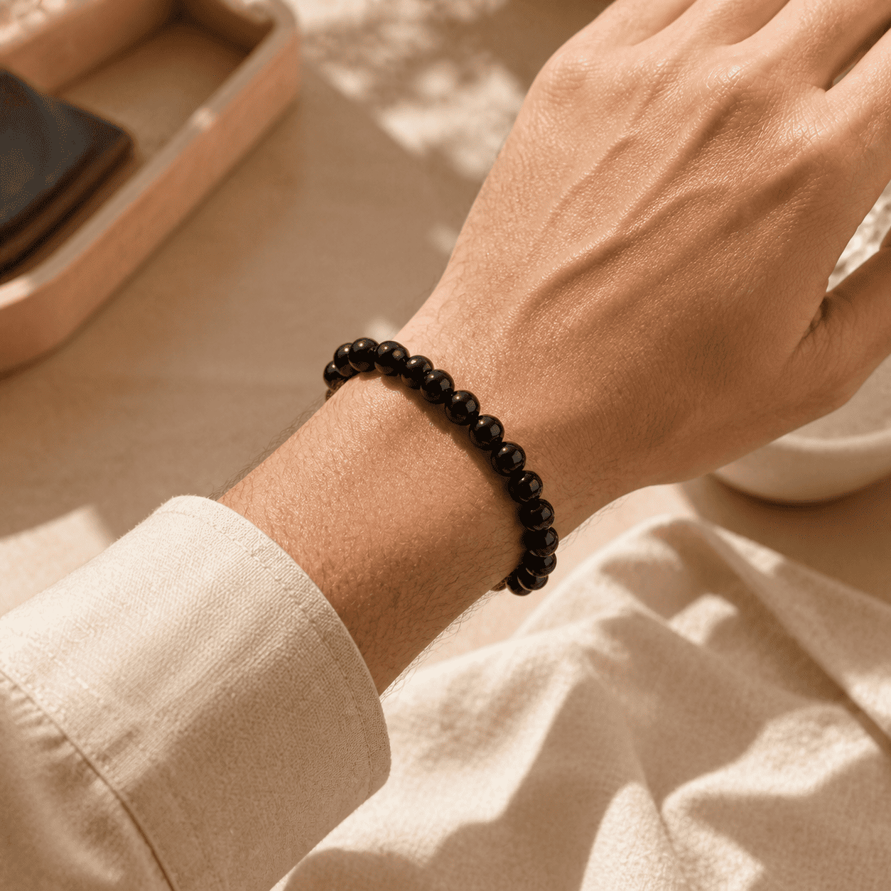 Black obsidian bracelet for men worn on the wrist with small polished round beads