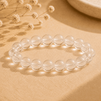 Natural clear quartz bracelet with large polished transparent round beads on neutral fabric