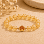 Golden rutilated quartz bracelet with large transparent round beads and a gold-tone S925 star charm