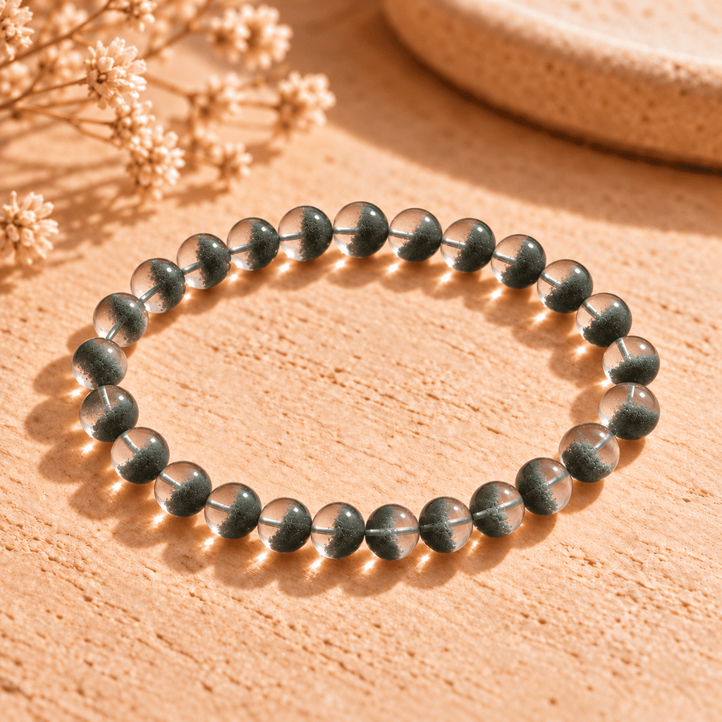 Green phantom crystal bracelet arranged in a wide oval, with green inclusions visible through clear round beads