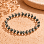Green phantom crystal bracelet arranged in a wide oval, with green inclusions visible through clear round beads