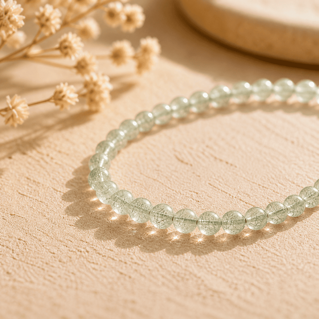 Green Rutilated Quartz bracelet on a warm natural background, a soft Green Crystal Bracelet with delicate inner threads