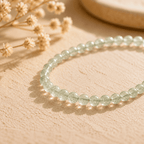 Green Rutilated Quartz bracelet on a warm natural background, a soft Green Crystal Bracelet with delicate inner threads