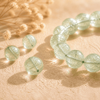 Green Rutilated Quartz loose bead detail with sparkling natural crystal inclusions beside the bracelet