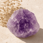 Raw purple amethyst crystal stone displayed in sunlight