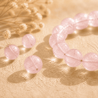 Rose quartz bracelet displayed with loose polished pink beads