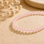 Rose quartz bracelet with small polished pink beads in natural light