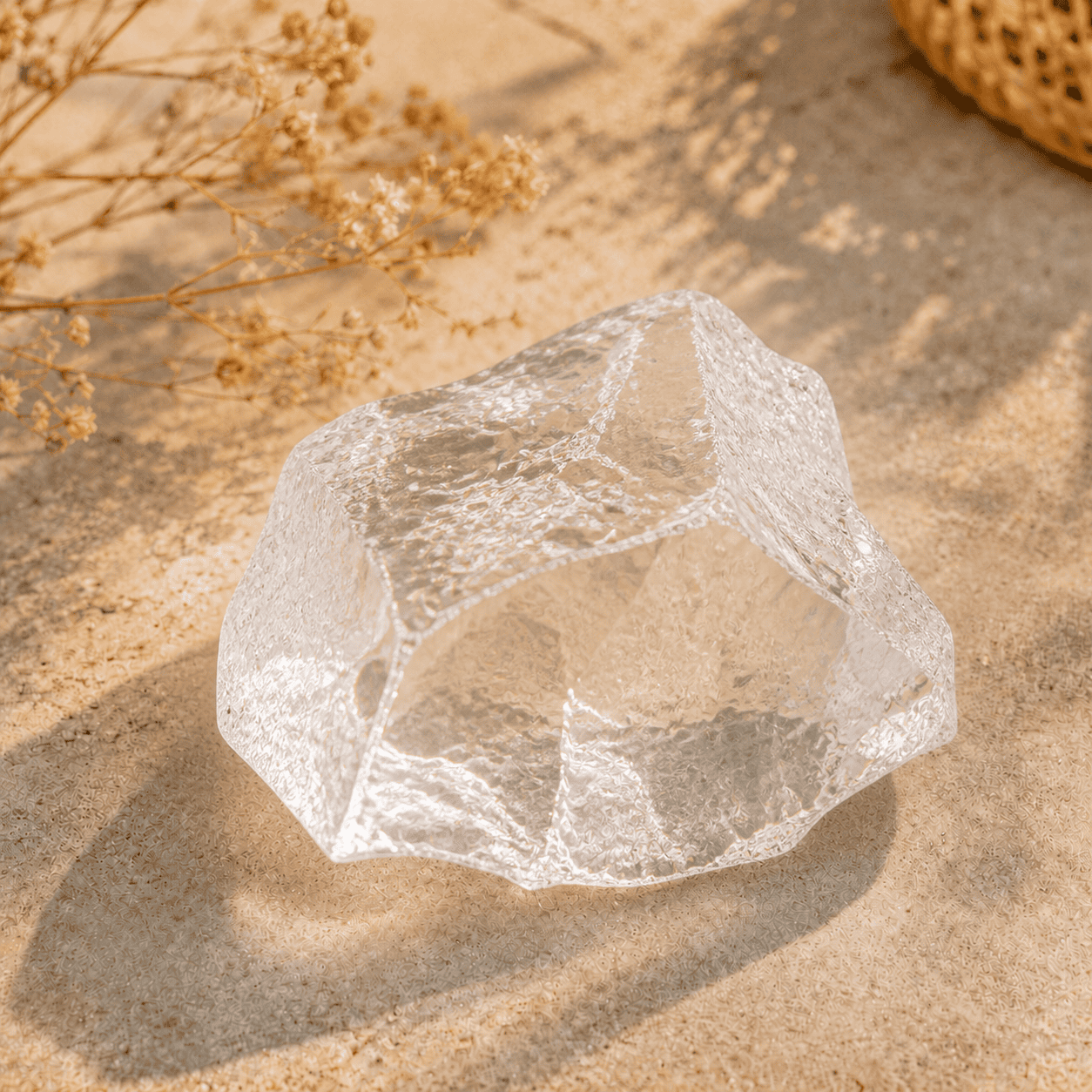 Raw clear quartz crystal stone with transparent natural texture photographed in warm sunlight