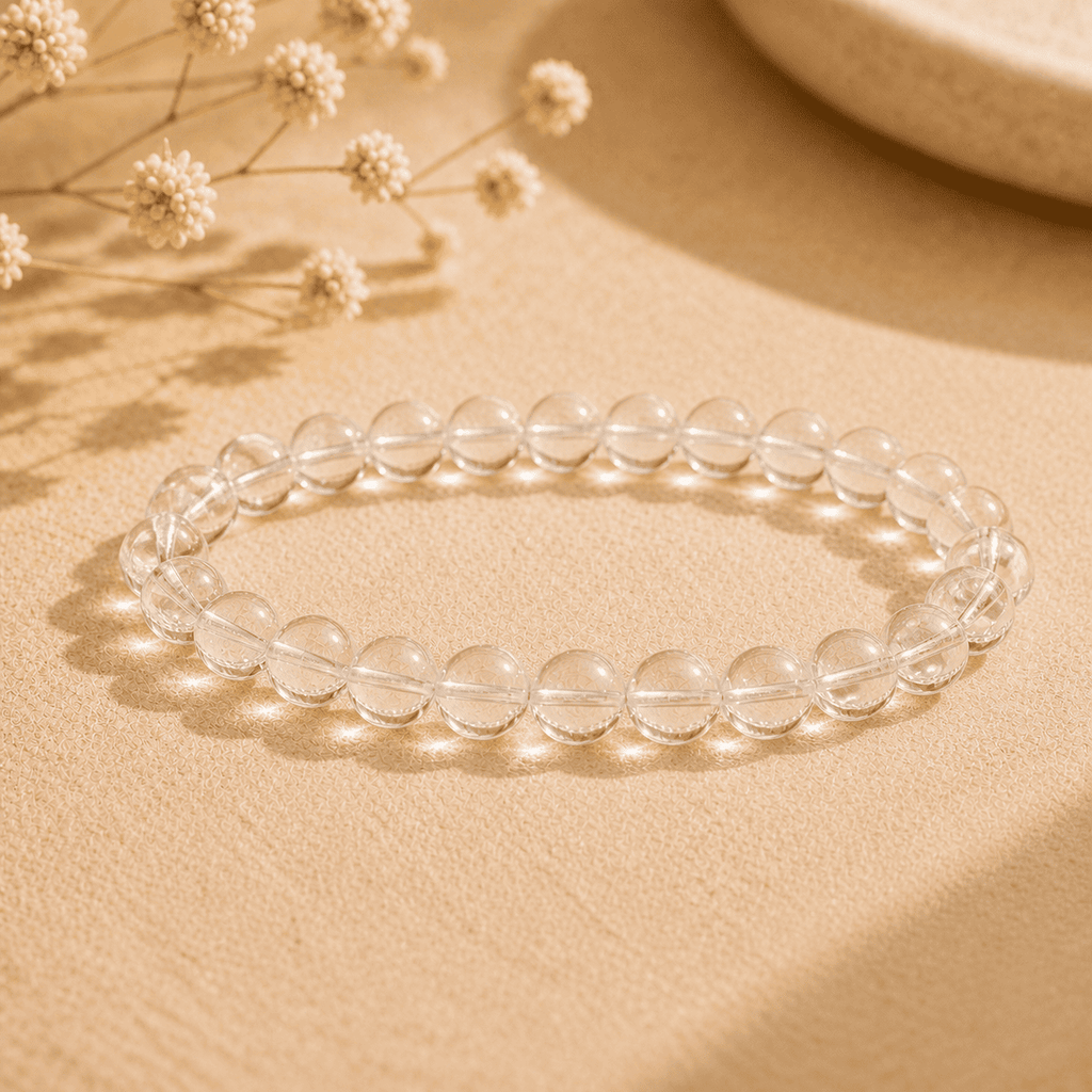 Real clear quartz bracelet with polished transparent round beads displayed in warm natural light