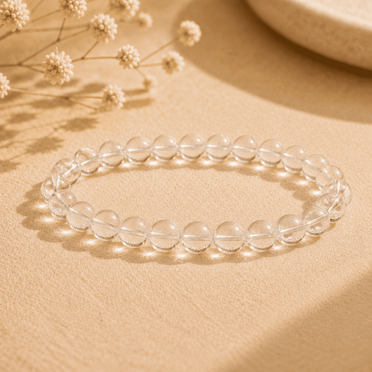 Real clear quartz bracelet with polished transparent round beads displayed in warm natural light