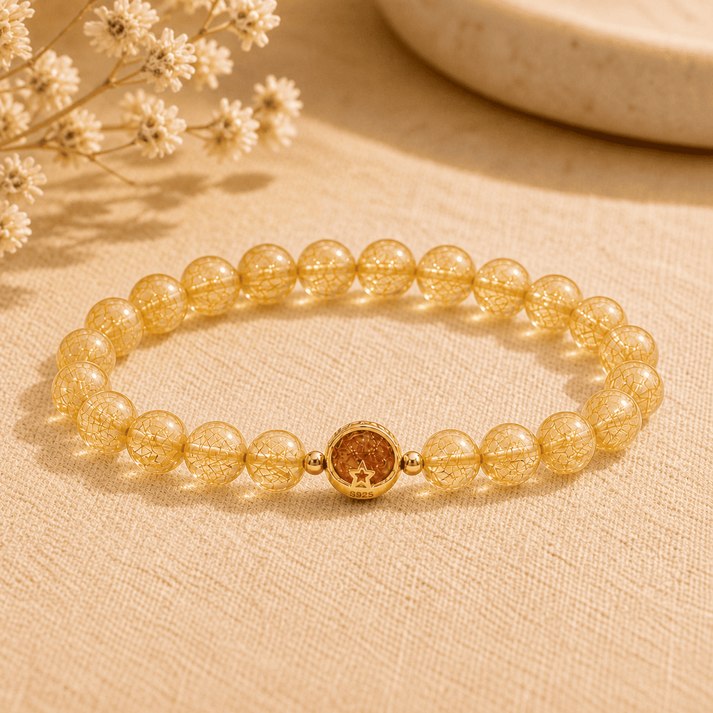 Rutilated quartz crystal bracelet for women with medium golden needle-inclusion beads and an S925 star charm