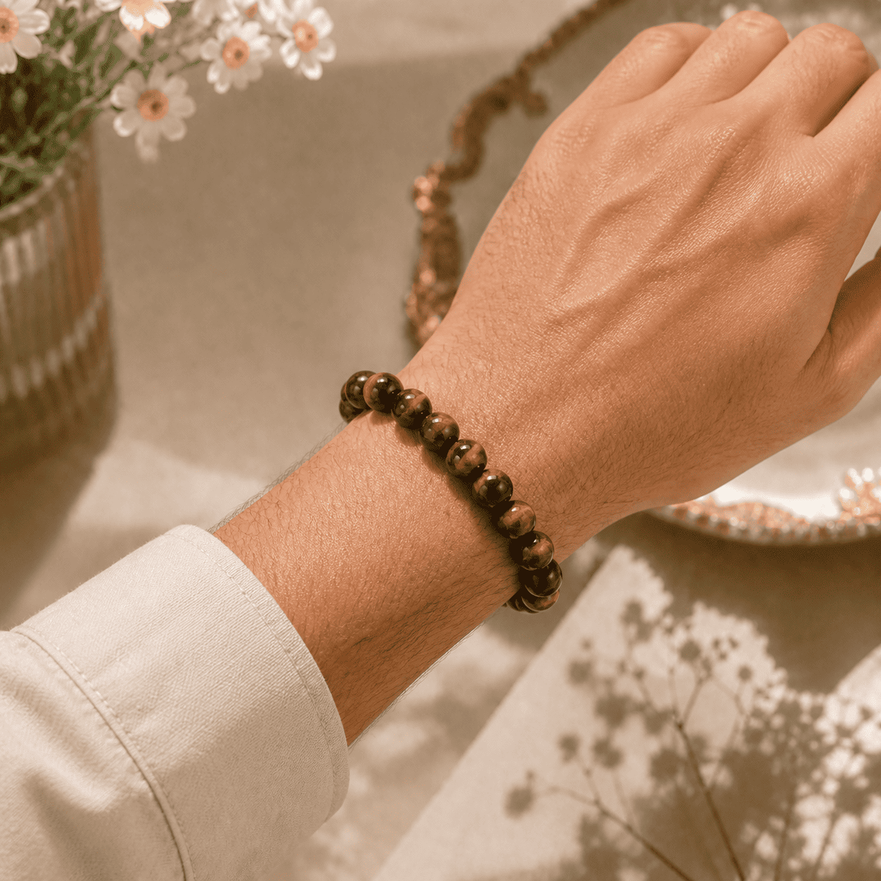 Tiger eye stone mens bracelet worn on the wrist with small polished golden brown beads